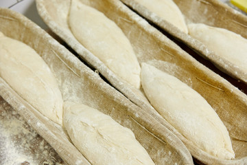 pieces of dough in a row in a bowl, pastries, flour products