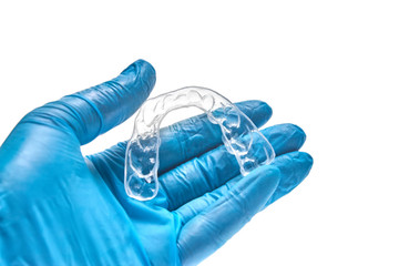 Hand holding individual dental tray for bleaching teeth Isolated on a white background
