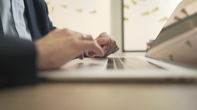 Business man is writing an email on his apple macbook