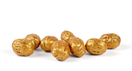 Golden walnuts on a white background