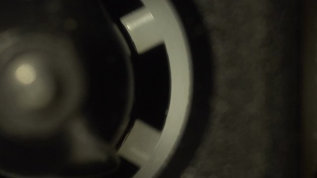 Half of a reel of a vintage audio cassette macro rotating in the tape recorder