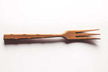 Wooden fork on white background
