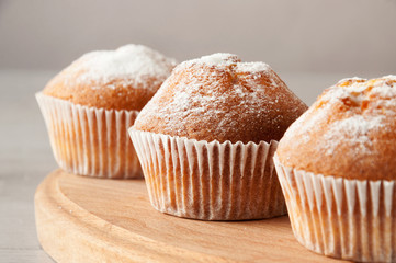 Tasty muffin closeup on a wooden board, selective focus.