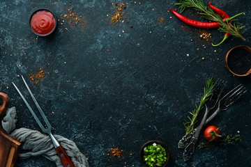 Dark cooking banner. Vegetables and spices on the kitchen table. Top view. Free space for your text.