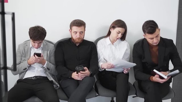 young businessmen waiting for interview sitting near office