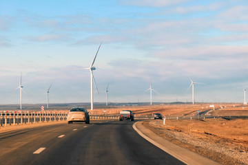 electromagnic wind generator at the highway against the sky with clouds at sunrise