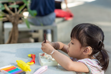 Hearing impaired children playing on the table in the park.