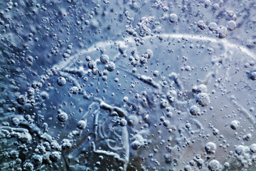 Ice surface in the form of molecules, oil and mercury. Planet surface. The surface texture of the ice.  Ice texture background. 