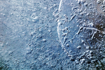 Ice surface in the form of molecules, oil and mercury. Planet surface. The surface texture of the ice.  Ice texture background. 