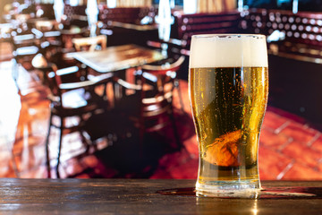 Glass of fresh beer at the bar.