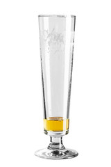 Beer glass almost empty. Small amount of lager beer on the bottom  isolated on a white background.