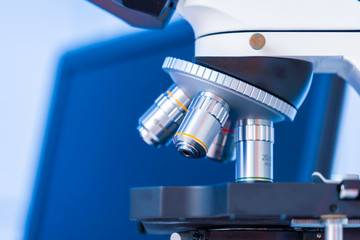 Scientific experiment in microbiological lab. Microscope and test tube
