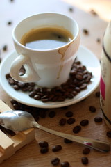 A cup of coffee and coffee beans