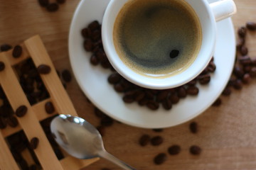 A cup of coffee and coffee beans