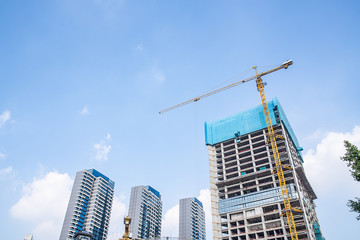 Fototapeta na wymiar Upside-down shot of city construction site cranes and real estate
