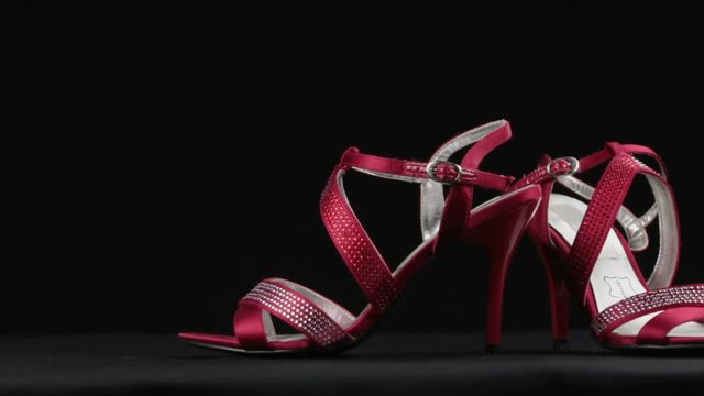 Close-up, a pair summer high-heeled shoes in rhinestones. Slider shot. Female fashion.