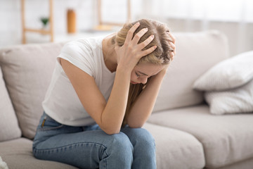 Desperate young woman suffering from loneliness at home
