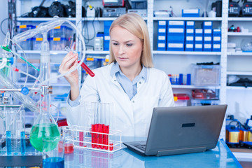 Girl laboratory Assistant.works with an antiviral drug in a laboratory