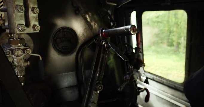 Detail Train Conductor hand shifting gear, inside vintage steam train