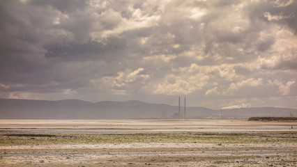 A view of Dublin Bay from the cliffs at Red Rock, Sutton, County Dublin, Ireland. The twin towers of Poolbeg power station can be seen in the distance.