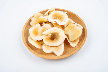 Dried seafood snails on a plate on white background