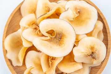Dried seafood snails on a plate on white background