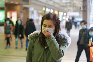 Fototapeta premium masked girl to protect herself from wuhan virus in public area