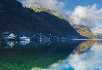Hallstatt, a charming village on the Hallstattersee lake and a famous tourist attraction, with beautiful mountains surrounding it, in Salzkammergut region, Austria, in winter sunny day.