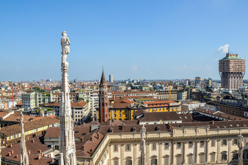 Fototapeta na wymiar Aerial view of Milan from Duomo roof terrace, Italy. Visible Tower Velasca and Bell Tower in Saint Gottardo in Corte, Italy 