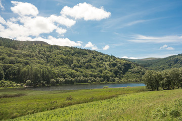 The Lower Lake and hilly woodland on a Summer's day at Glendalough National Park, County Wicklow, Ireland.