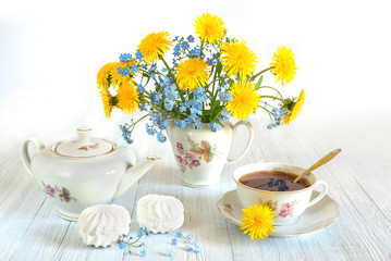 Bouquet of spring flowers. Spring still life of dandelions, forget-me-nots and cups of tea. Isolated on white background