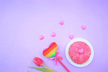 Valentine's day concept. bouquet of flowers, pink tulips. Pink hearts, gift box. Pink donut. LGBT colors.