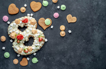 number plate cake of 8 decorated with flowers, cream of cheese, marshmallows, Bizet on a stone background. postcard International Women's Day March 8