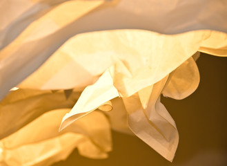 warm and yellow light falls through different layers of paper, light and shadow