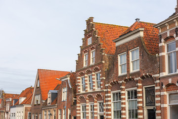 Fototapeta na wymiar The upper part of traditional Dutch houses in the city historic centre