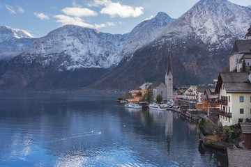 Hallstatt, a charming village on the Hallstattersee lake and a famous tourist attraction, with beautiful mountains surrounding it, in Salzkammergut region, Austria, in winter sunny day.