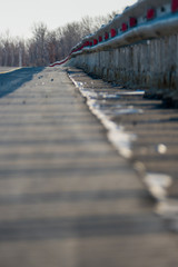 Obraz premium Shadows on the asphalt from the railing