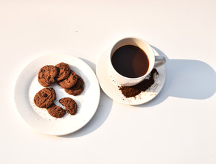 Black coffee in a white cup Cookies in white dish Putting on a white background
