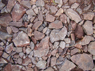 Large crushed stone for the background. Chipped rock. Color - shades of brown.