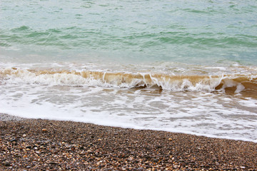 Wave on the beach background texture. Beautiful clear water lapping on the shore. waves on sea coast. 