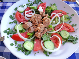 Tuna salad on a plate. Delicious and healthy dish of tuna and fresh vegetables