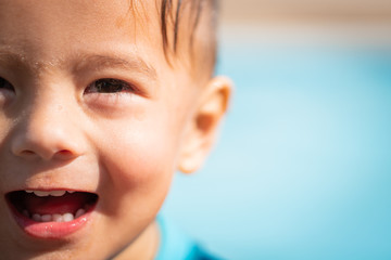 cute young mixed race boy smiling in the sun