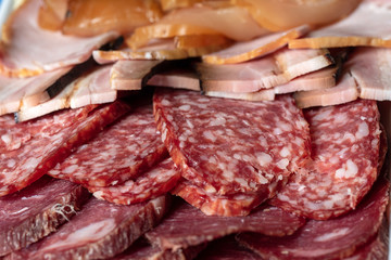 Beautiful sliced various sausages laid out on top of each other close up