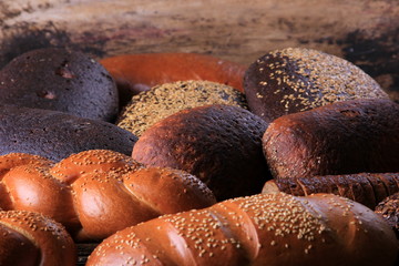 Fresh collection of bread and wheat on the table. Collection of different types of bread: White, rye, seed, form bread. lots of photos of bread with rye ears