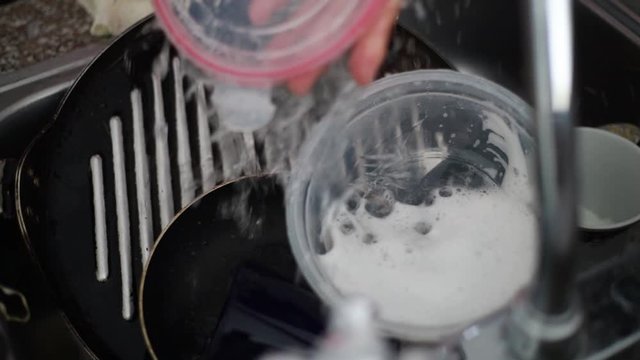 Wash Rinse Plastic Container in Kitchen Sink Under Running Water CLOSE