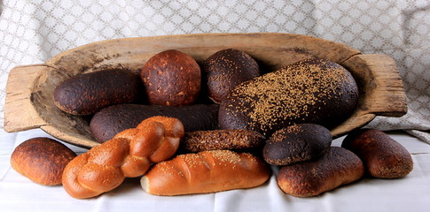 Fresh collection of bread and wheat on the table. Collection of different types of bread: White, rye, seed, form bread. lots of photos of bread with rye ears
