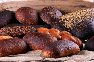 Fresh collection of bread and wheat on the table. Collection of different types of bread: White, rye, seed, form bread. lots of photos of bread with rye ears