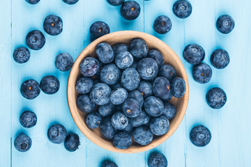 Fresh organic blueberries in wooden bowl