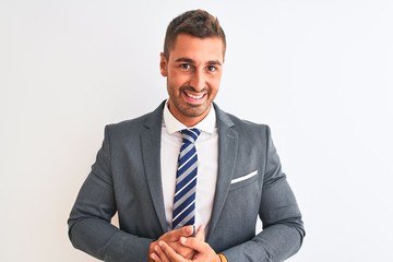 Young handsome business man wearing suit and tie over isolated background with hands together and crossed fingers smiling relaxed and cheerful. Success and optimistic