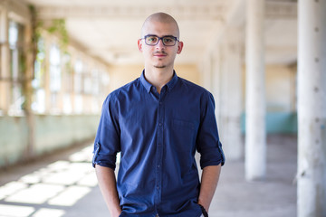 Cute, young man in blue shirt and with eyeglasses. Teen fashion